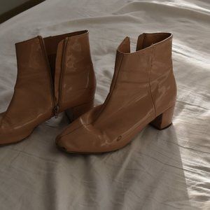 nude patent leather ankle bootie